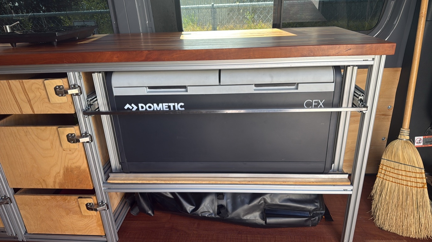 Dometic CFX slide-out refrigerator-freezer under cherry countertop