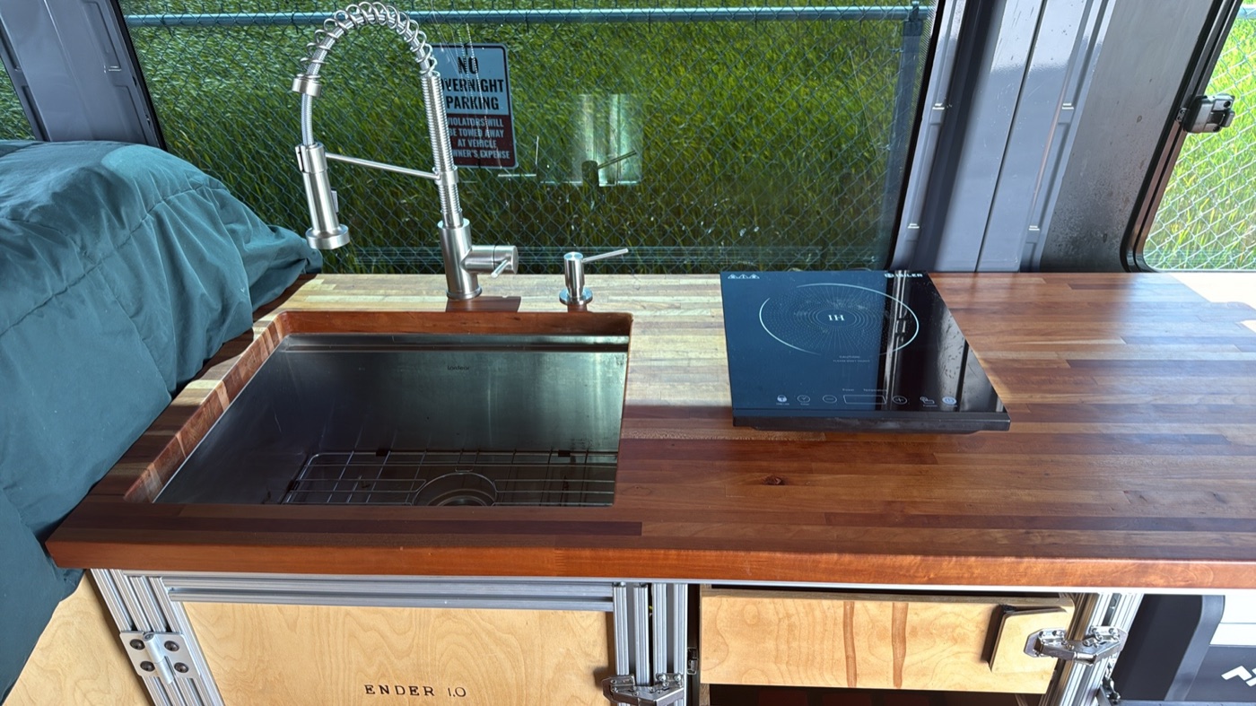 Walnut butcher-block galley with undermount sink and induction cooktop