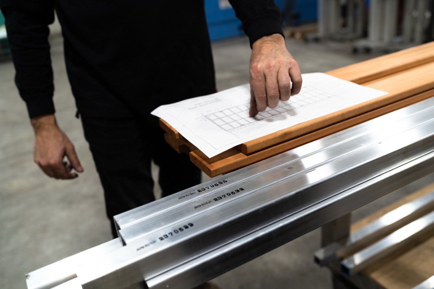 Aircraft-grade aluminum extrusion stock alongside Tigerwood lumber