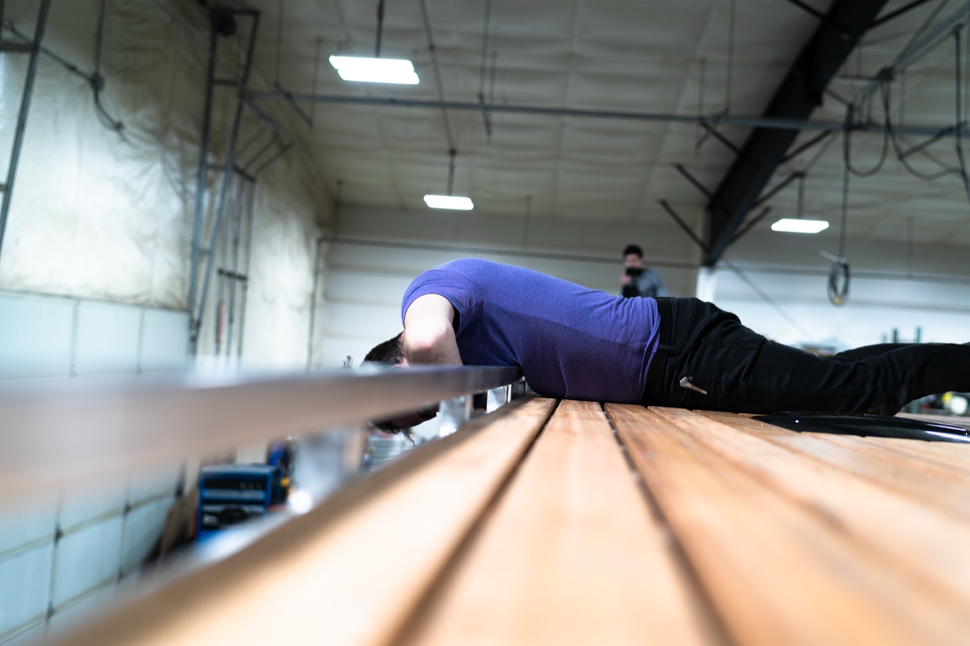 Low-angle view of the completed Tigerwood deck on the van roof