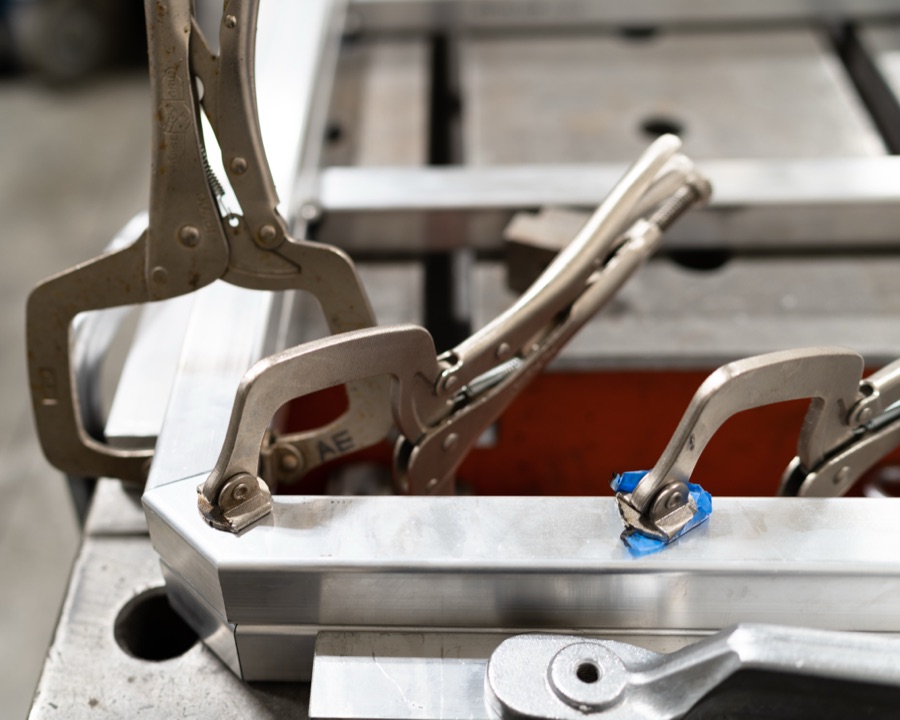 Locking clamps holding aluminum frame corners in place