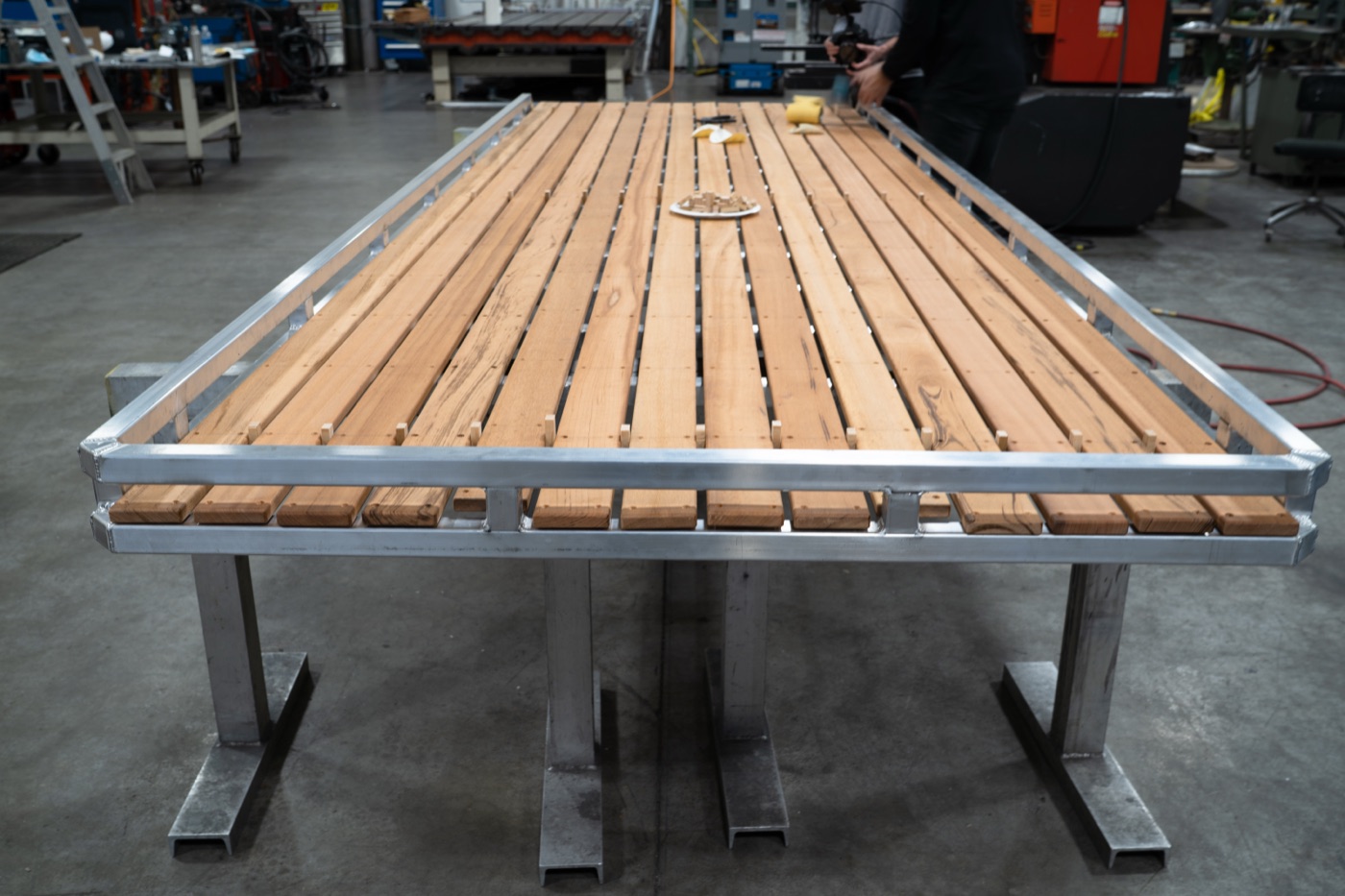 Completed Tigerwood roof rack standing on legs in the fabrication shop