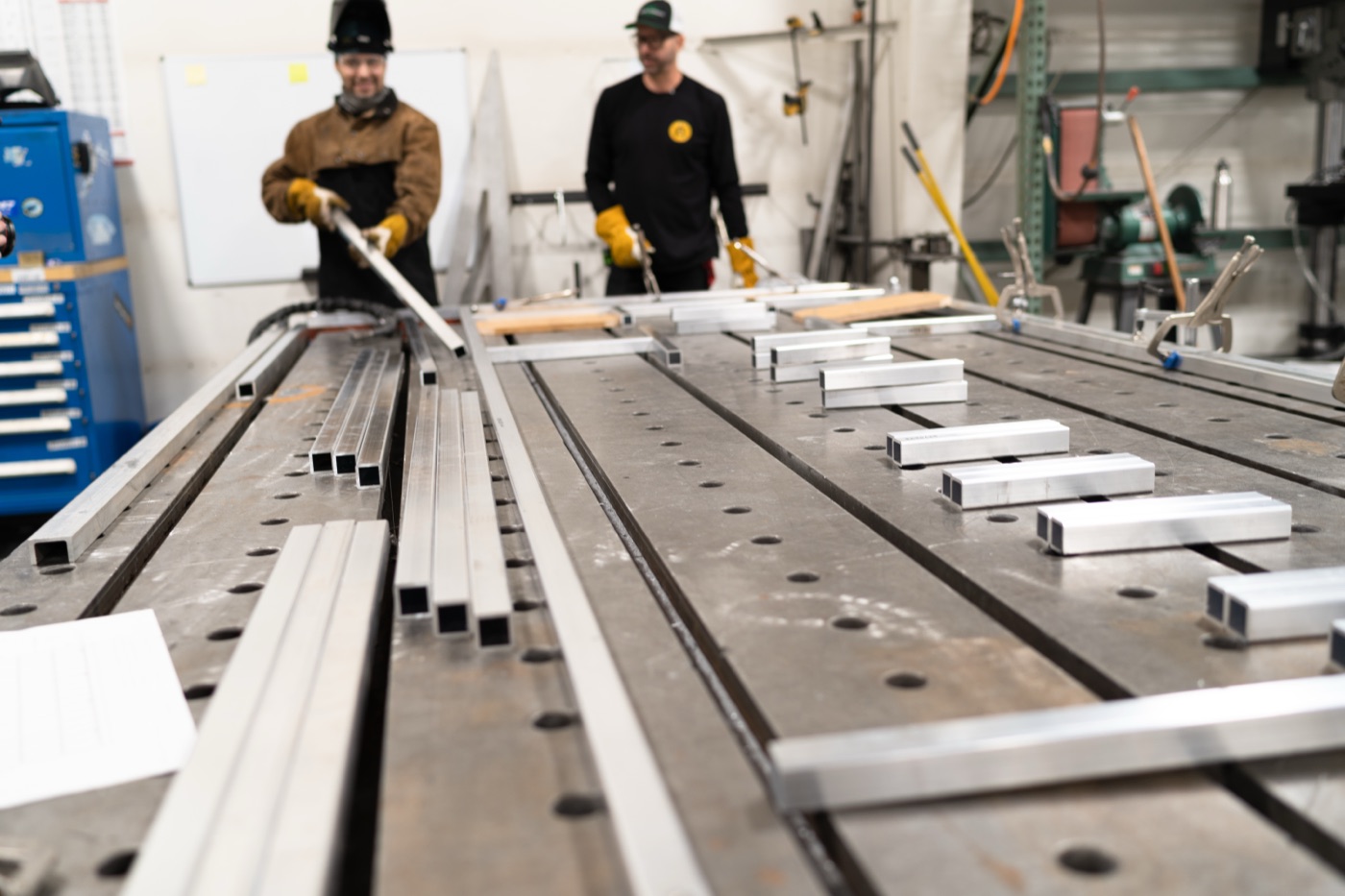Joe Clark's team positioning the aluminum frame on the welding table